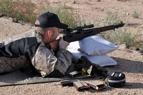 A man with a Rifle aiming the target