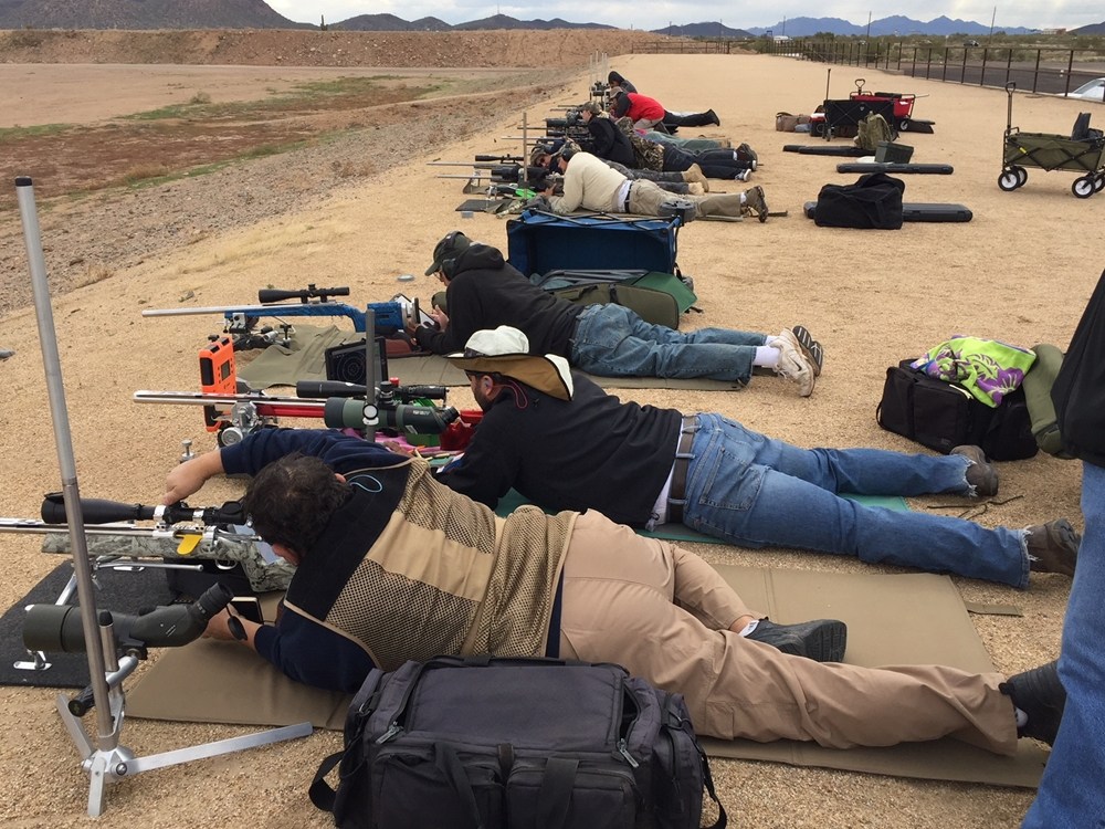 A group of people ready to aim target