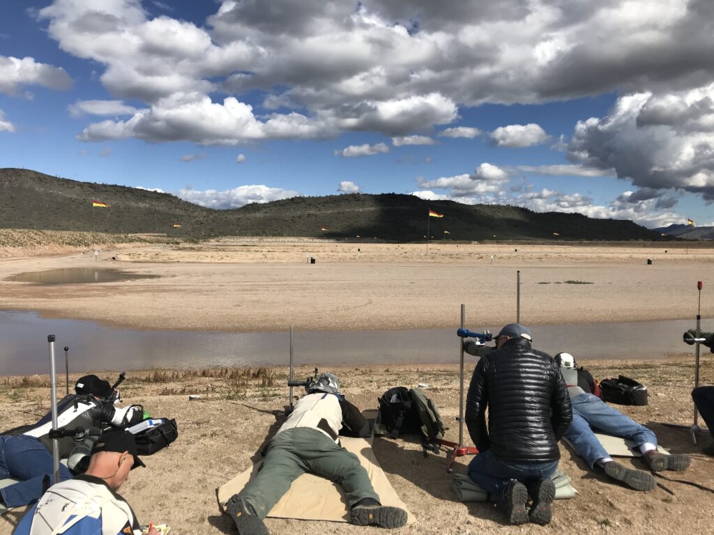 A group of people sitting on the beach